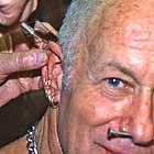 Doug Malloy piercing Sailor Sid Diller's ear