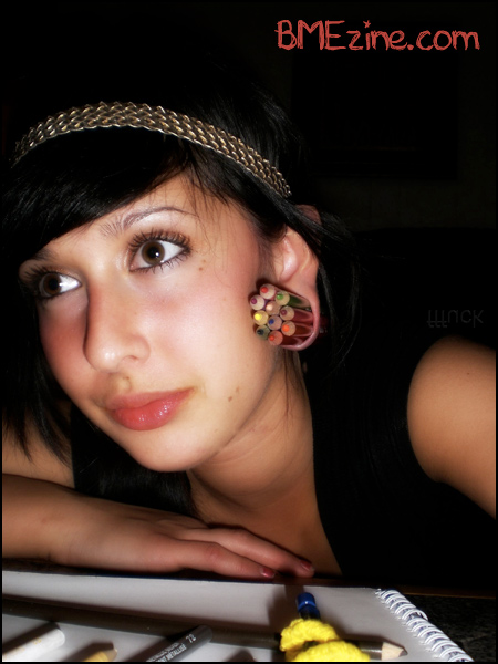 Stretched Ear Piercing Filled With Colored Penciles